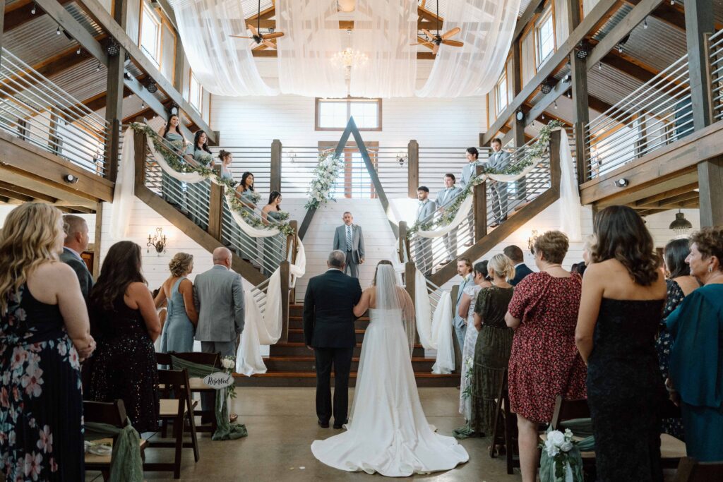 bride walking down the aisle with her father at nashville wedding venue