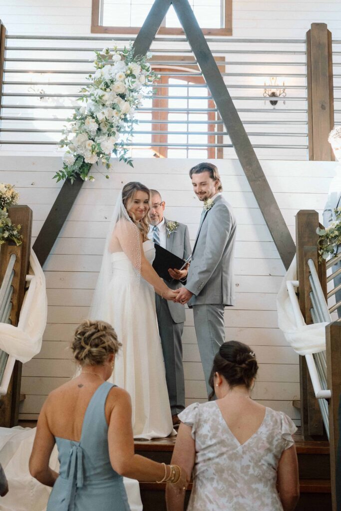 couple looking at their families lovingly while getting married in tennessee