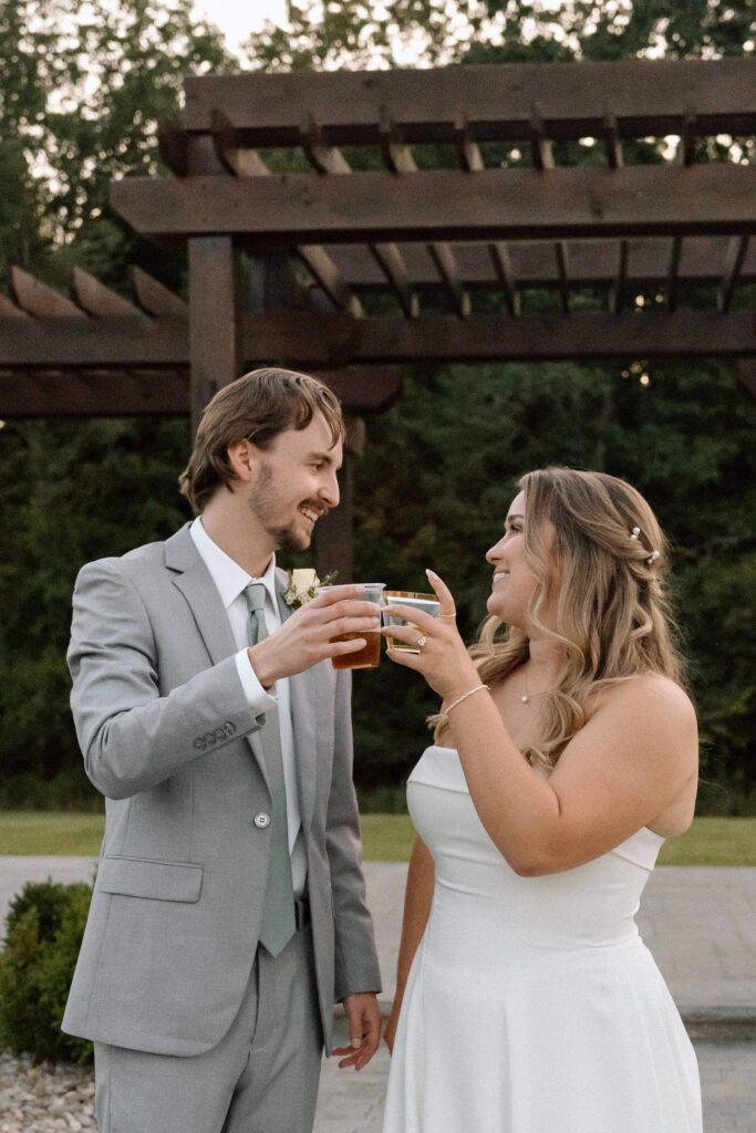 couple cheersing on their wedding day at fiddle dee farms venue