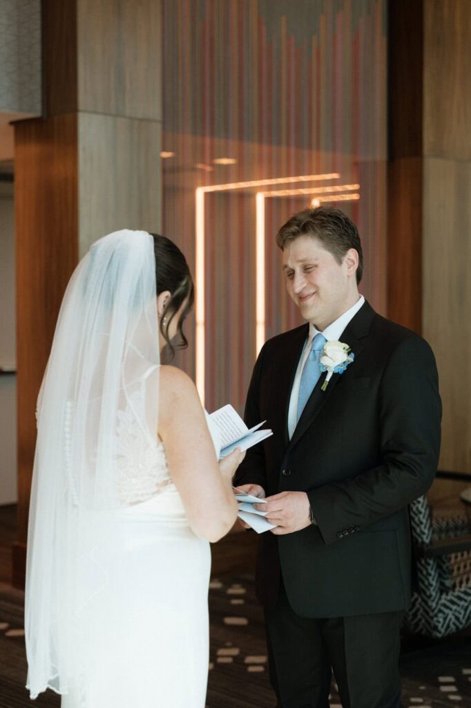 bride and groom reading private vows during first look in downtown nashville