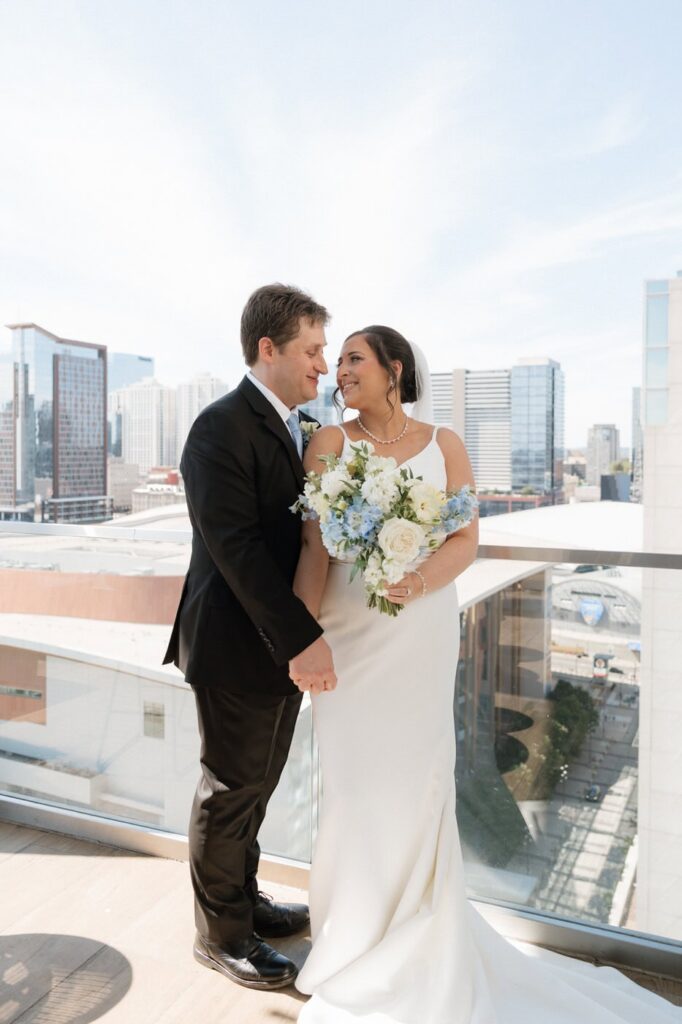 bride and groom in front of the nashville skyline