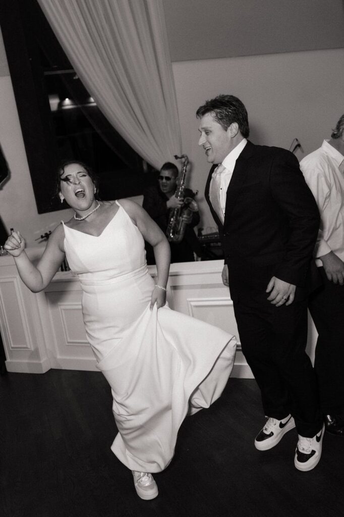 bride and groom dancing at reception in custom shoes