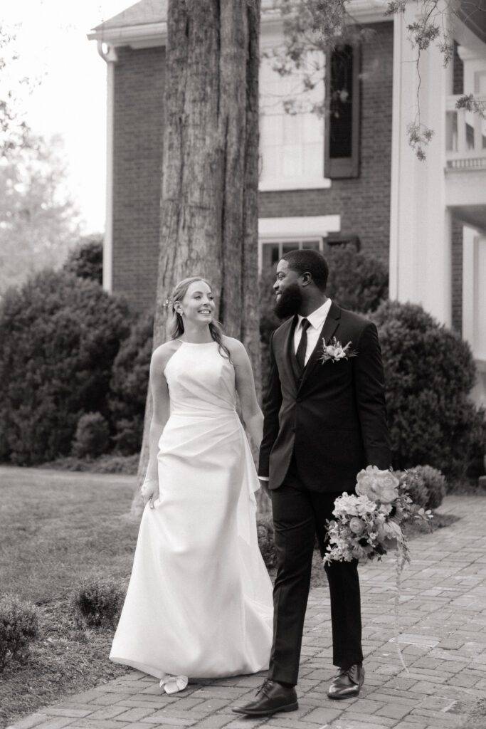 couple holding hands and walking before their wedding ceremony in franklin tennessee