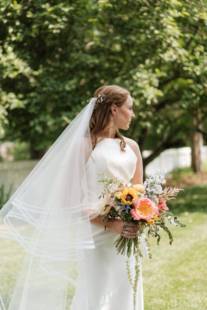 bride holding her summer inspired bouquet on wedding day