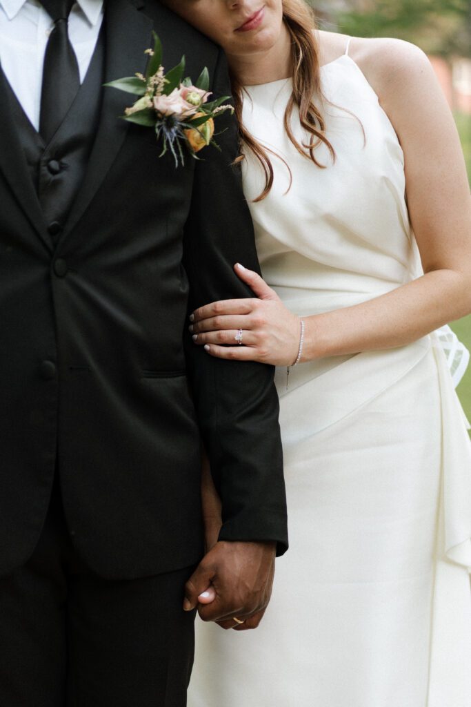 bride leaning on groom during newlywed portraits at cedarmont farm outside of nashville tennessee