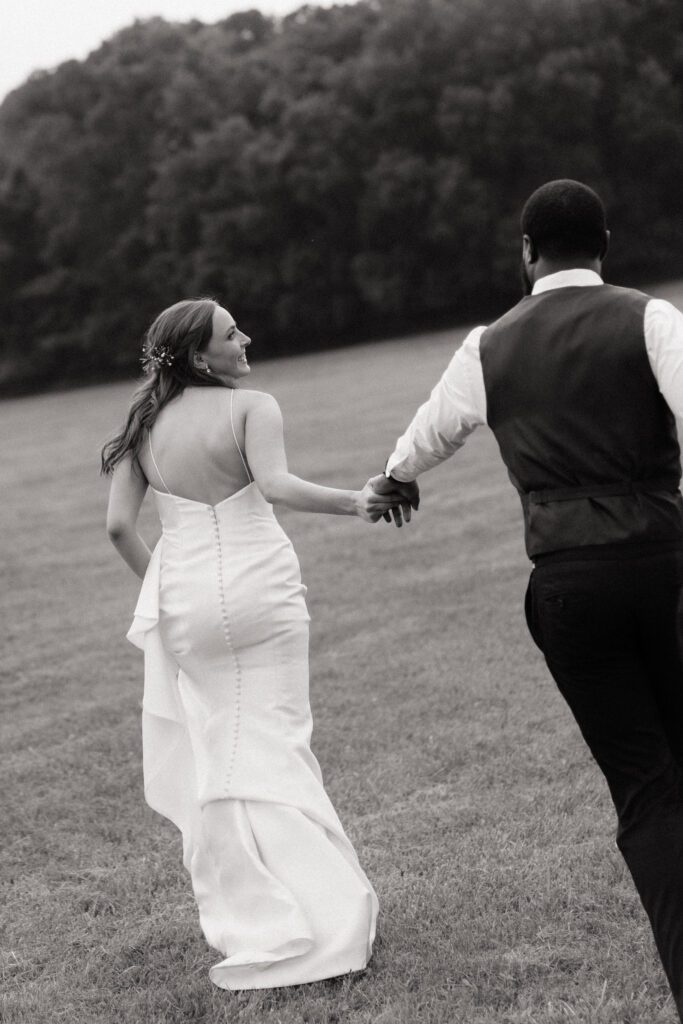 couple running through the lawn during sunset portraits at cedarmont farm in franklin tennessee