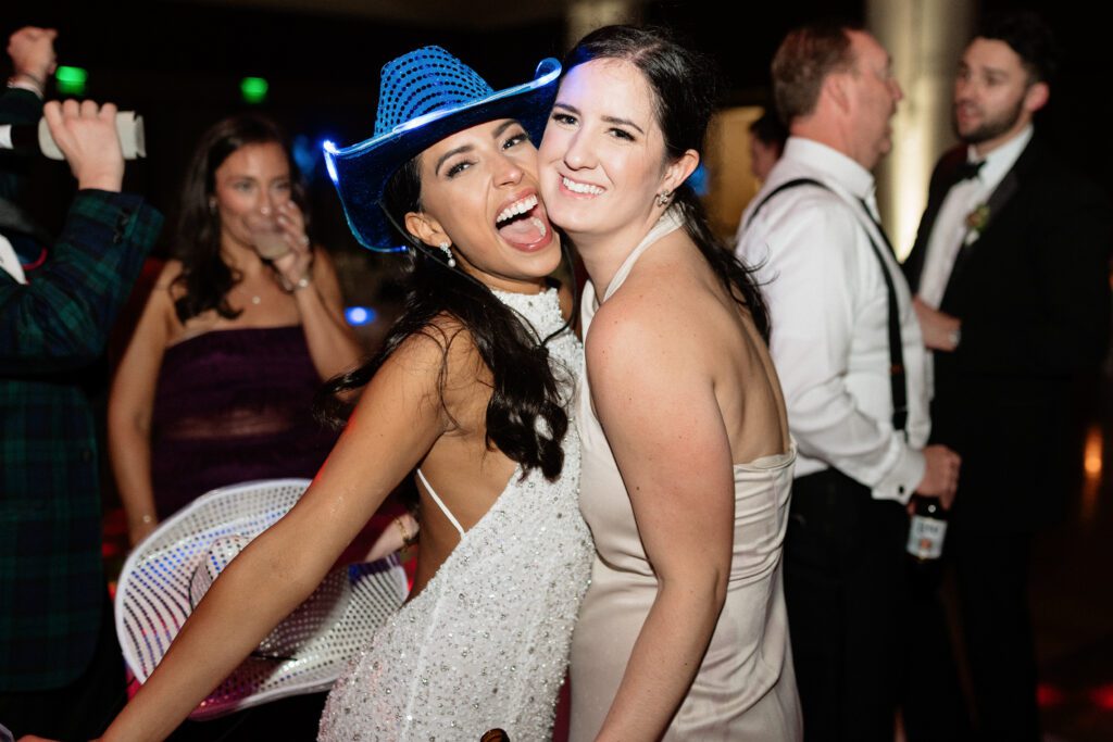 bride posing with her friend at country music hall of fame wedding reception in nashville