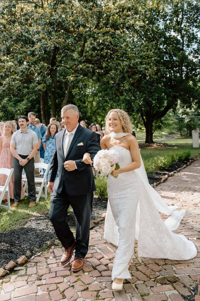 bride walking down the aisle with her dad at eader house wedding venue in tennessee