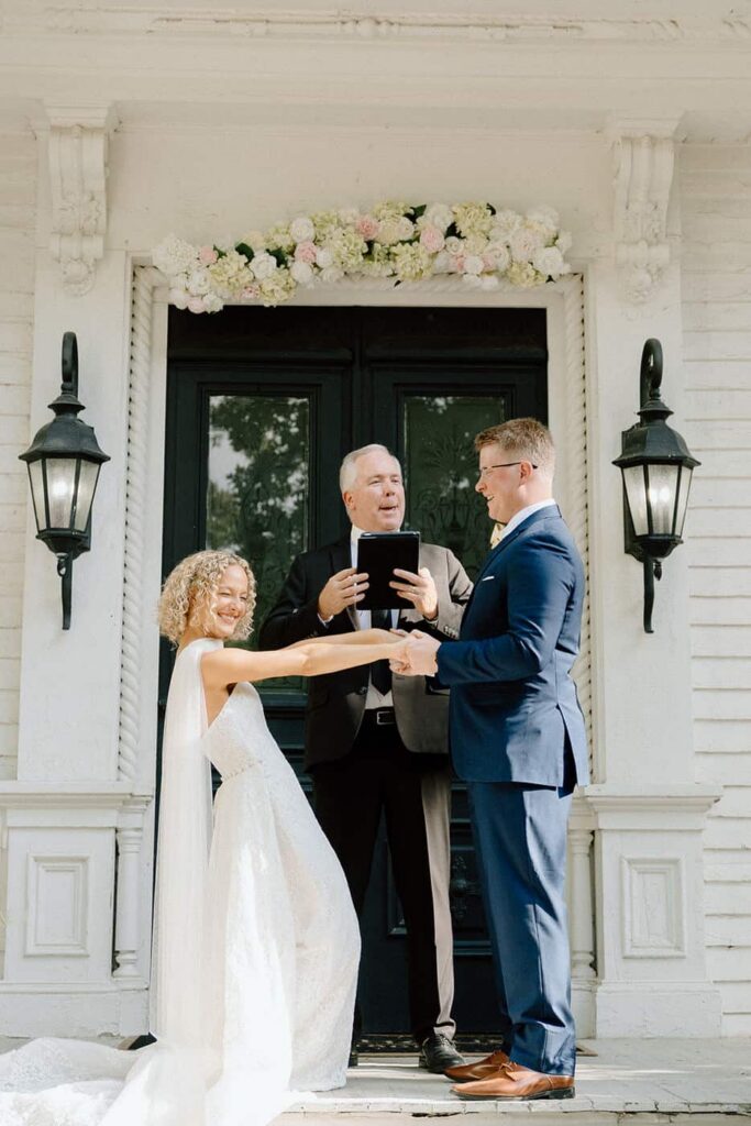 bride and groom sharing a laugh at the altar