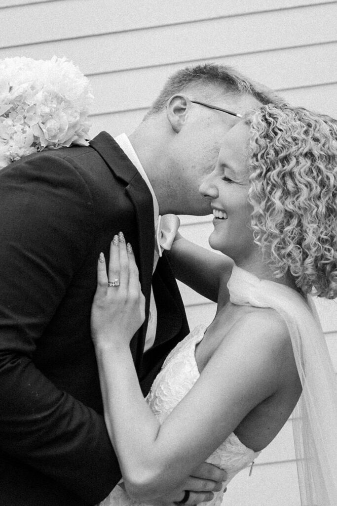 Bride and groom laughing during portraits