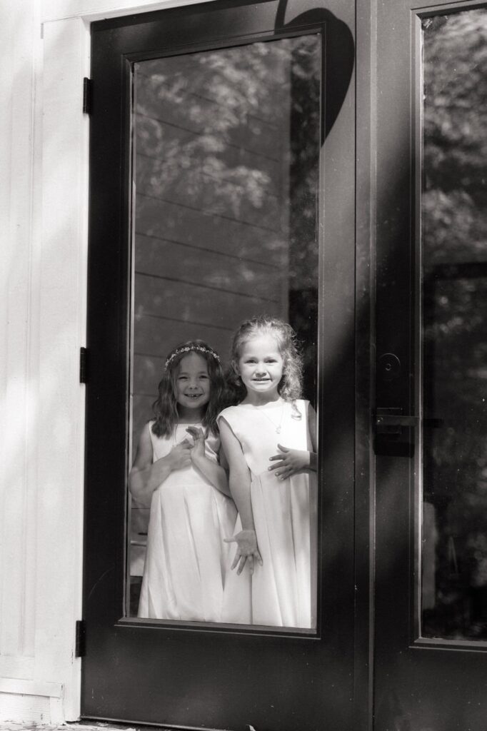 flower girls watching through the window at tennessee wedding