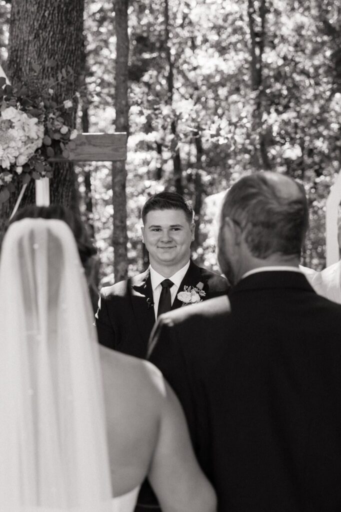 Groom watching bride walk down the aisle at tennessee wedding ceremony