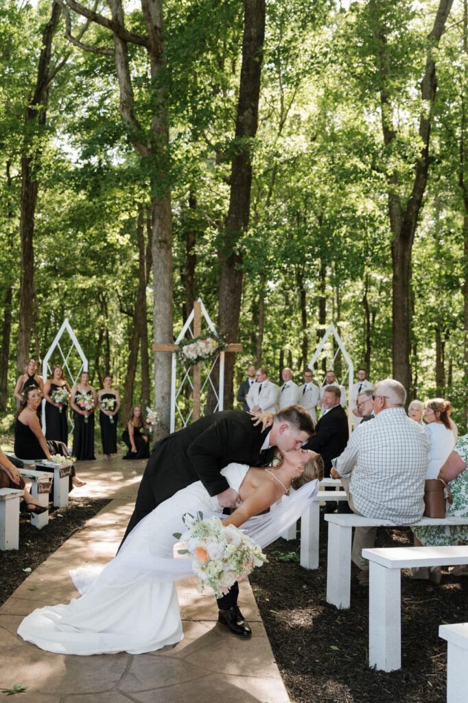 couple kissing at the end of the aisle at their spring wedding in tennessee