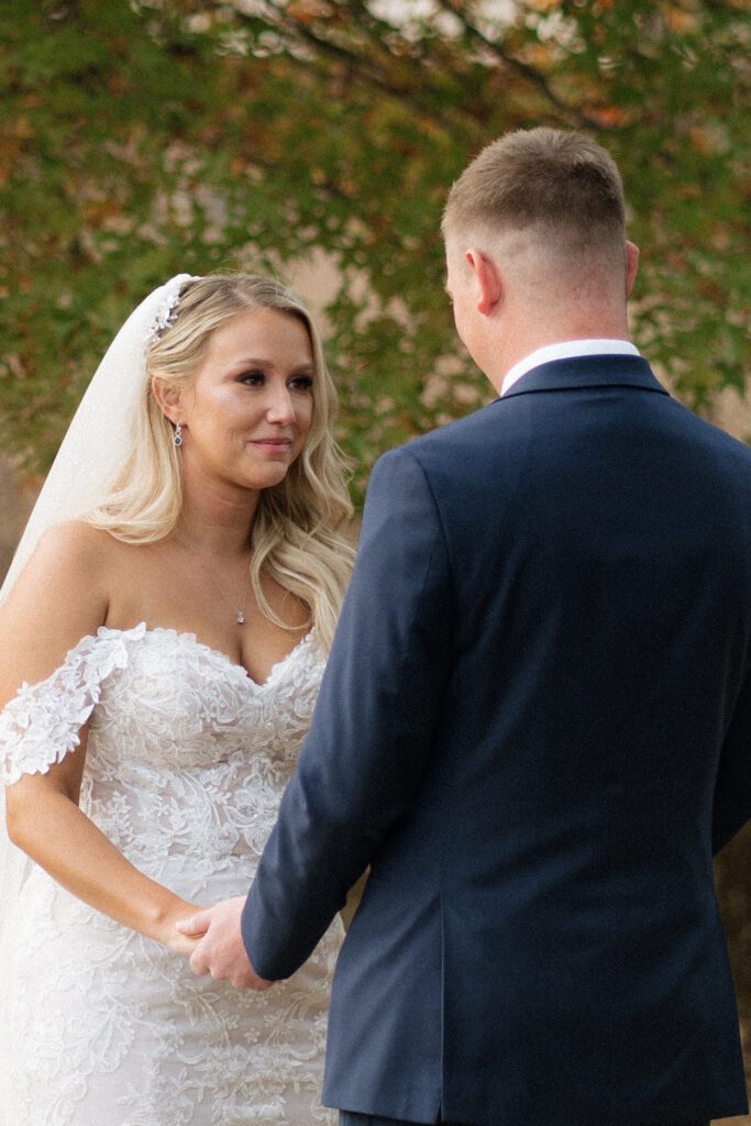 bride smiling at the groom during vows at wedding ceremony