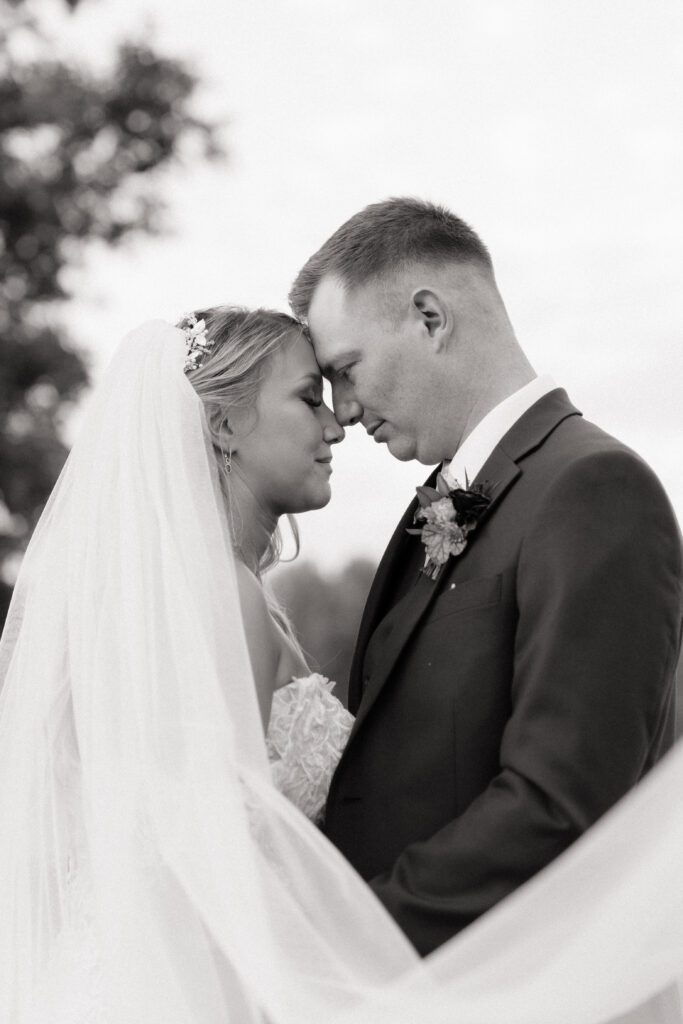 couple sharing an intimate moment during newlywed portraits on their wedding day