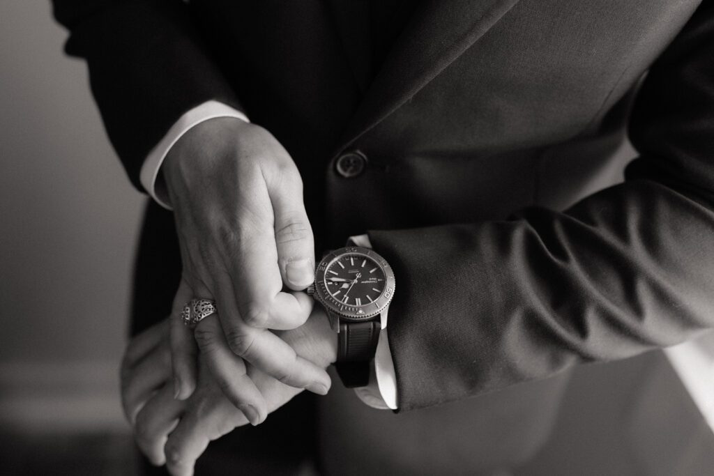 groom adjusting his watch during getting ready photos at nashville wedding venue