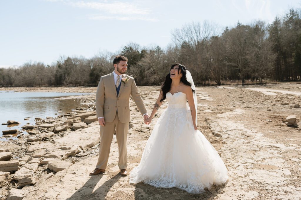 couple laughing and walking on the rocks at long hunter state park in nashville