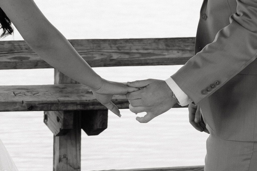 couple holding hands on the dock at long hunter state park