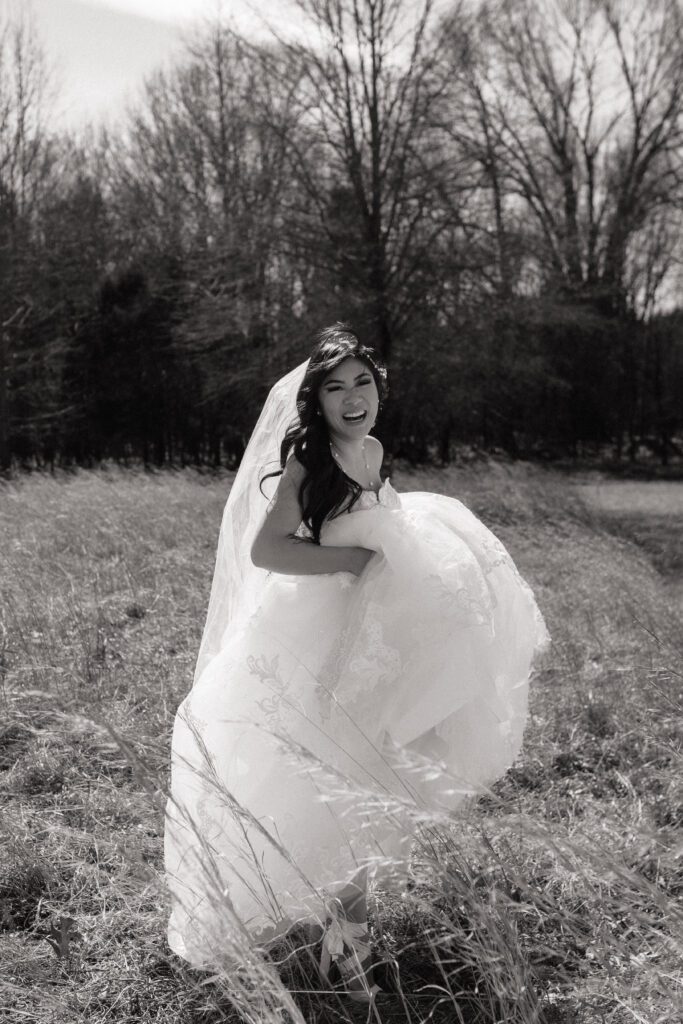 bride carrying her dress and laughing on her elopement day in tennessee