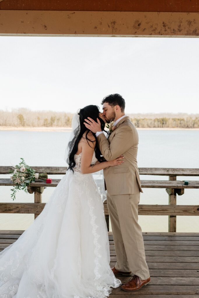 bride and groom kissing on their winter elopement day