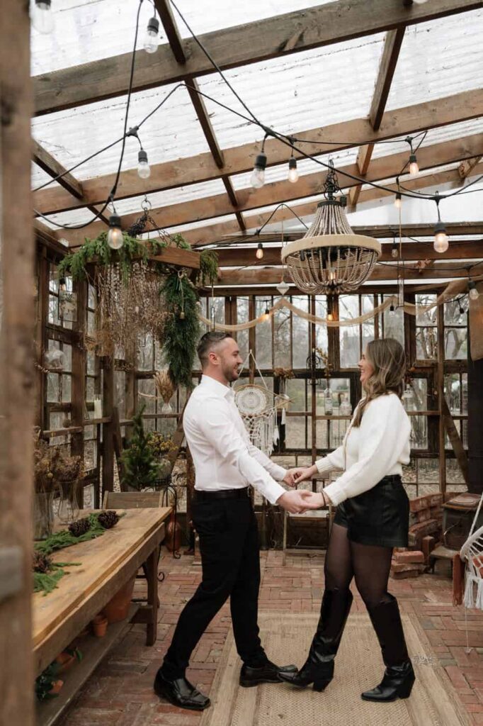 Candid engagement portraits at private Nashville greenhouse