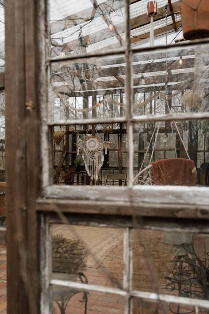 documentary style photo through the window of a greenhouse in nashville
