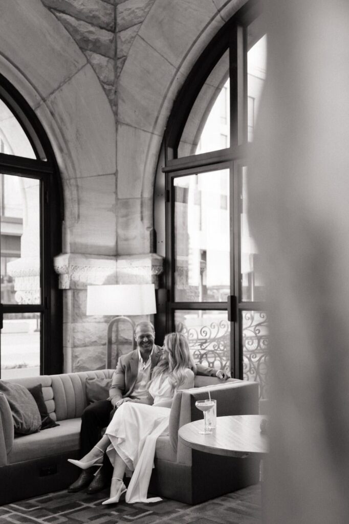 candid photo of couple laughing inside union station hotel