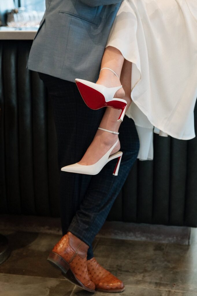 close up of red bottom heels during engagement session