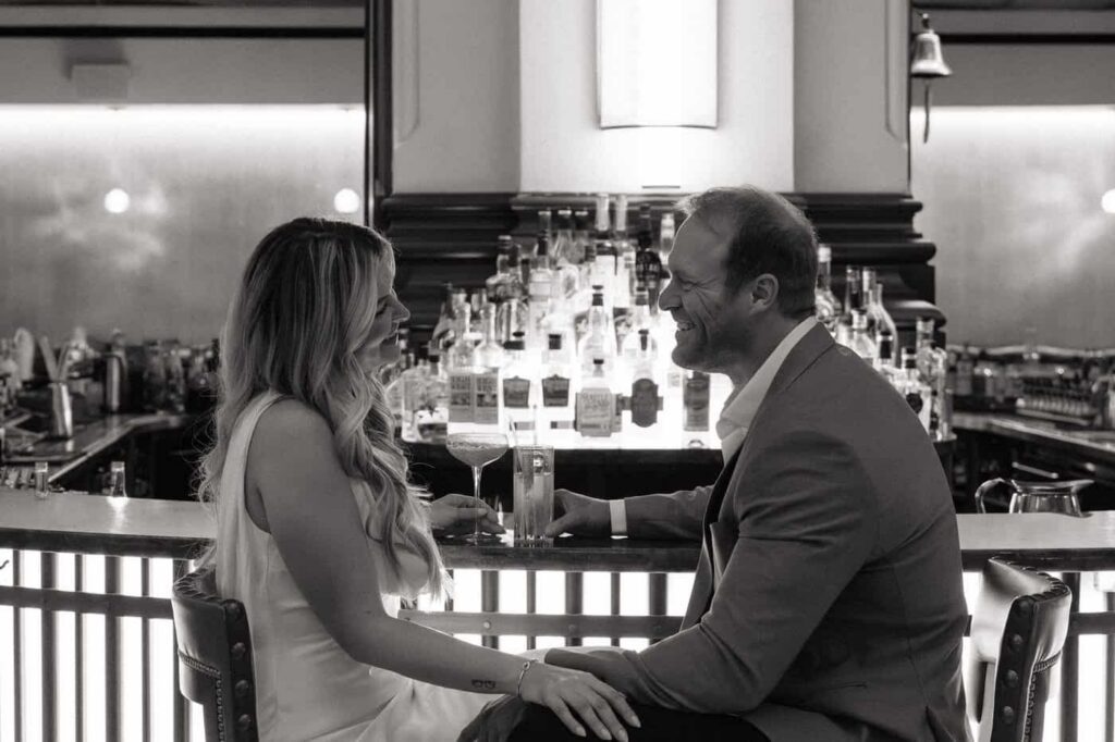Couple sharing cocktails during Union Station engagement session in Nashville