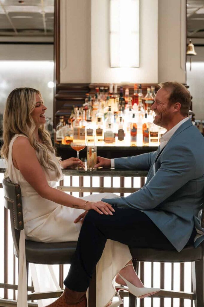 Couple sharing cocktails during Union Station engagement session in Nashville