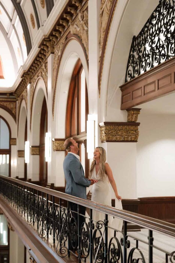 couple laughing in the union station hotel lobby during engagement photos