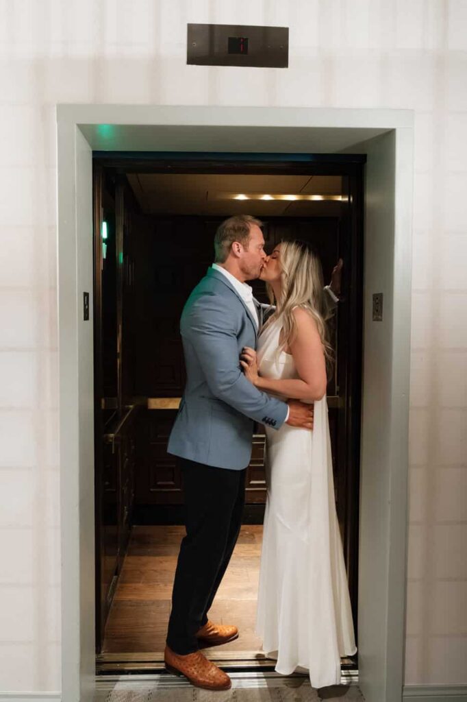 couple sharing a kiss in the union station hotel elevator