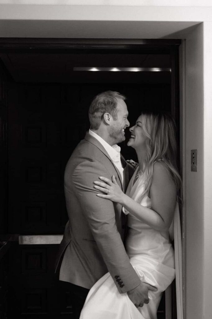 nashville engagement photographer documents couple laughing in union station elevator