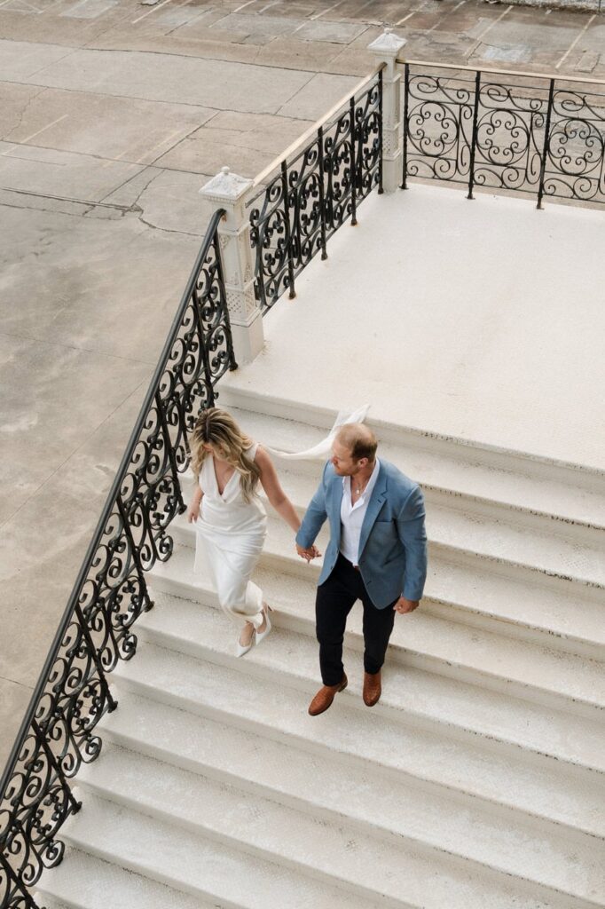 couple walking down the stairs of union station in downtown nashville