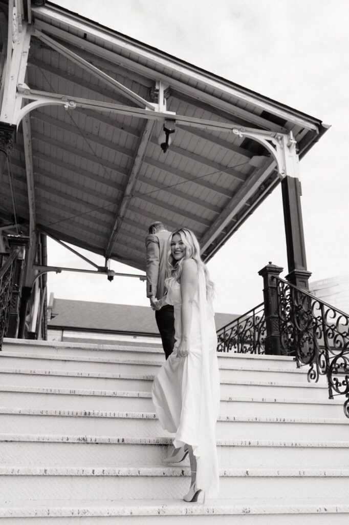 black and white image of couple walking up the stairs at union station hotel