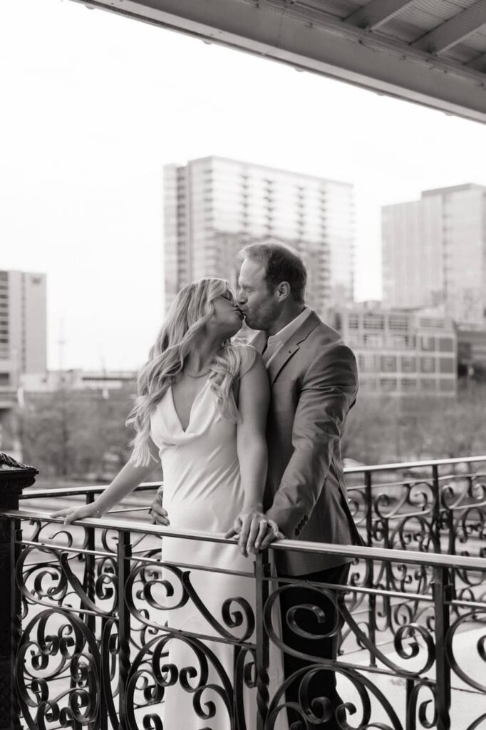 couple kissing outside in downtown nashville during engagement shoot