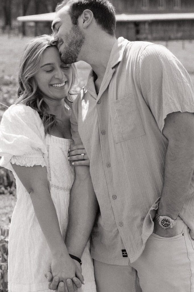 couple sharing a sweet moment during tulip farm engagement session in nashville