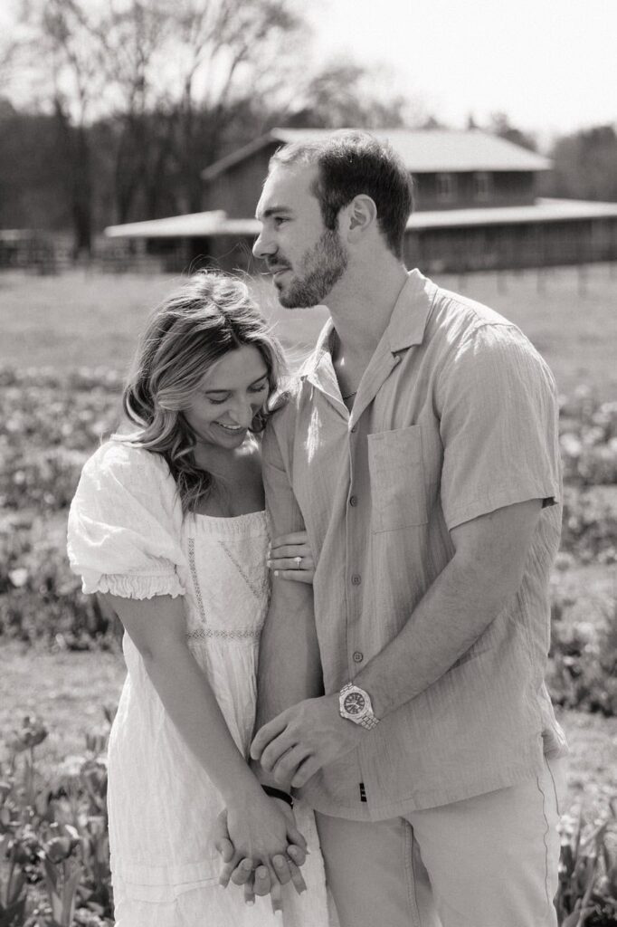 couple holding hands at flower farm in nashville