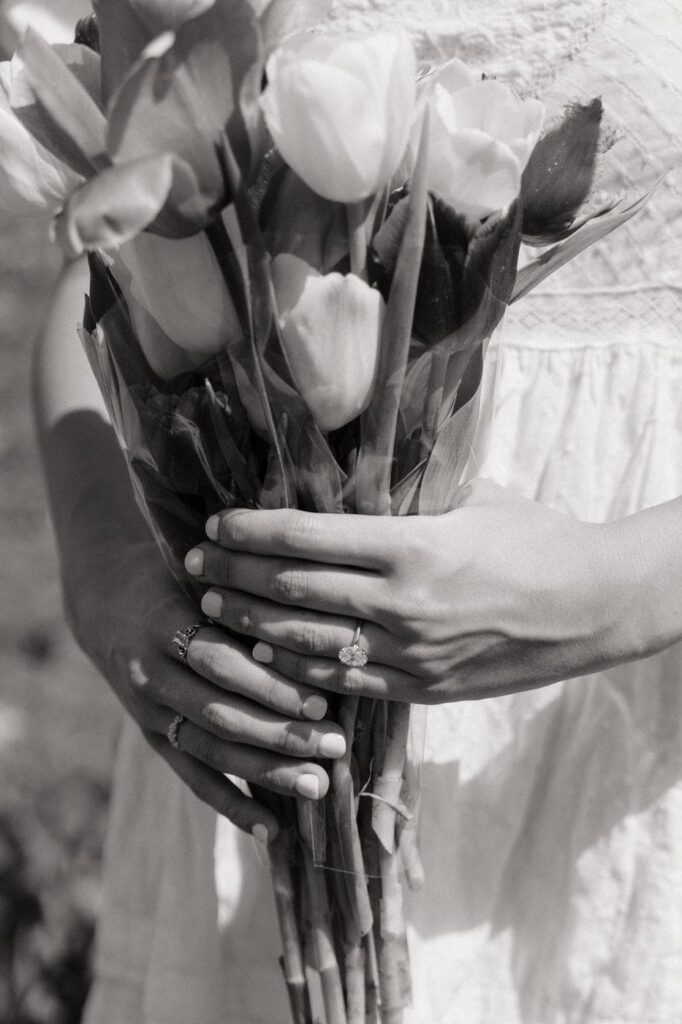 close up shot of tulips and engagement ring