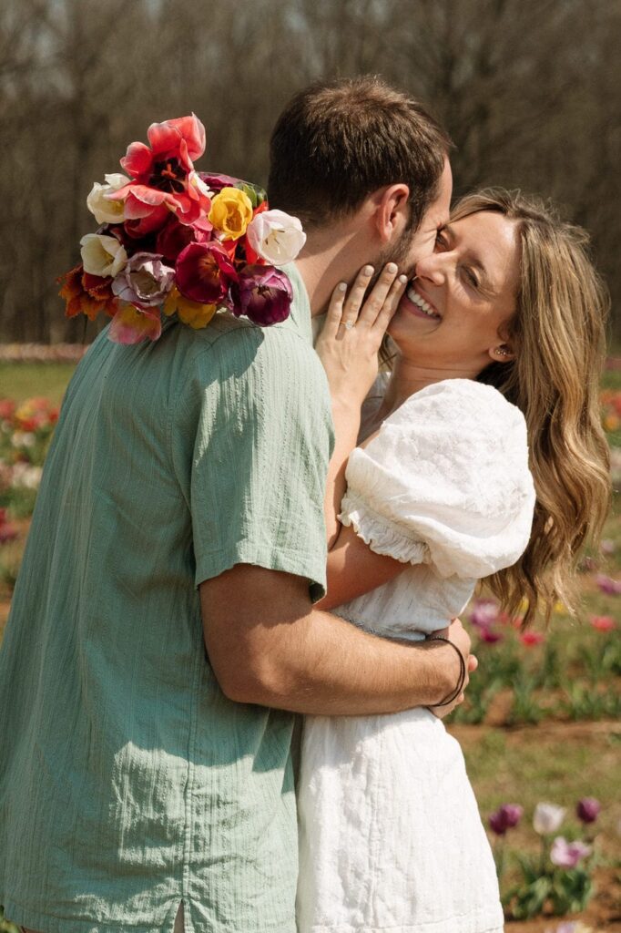 couple laughing and embracing at tulip farm