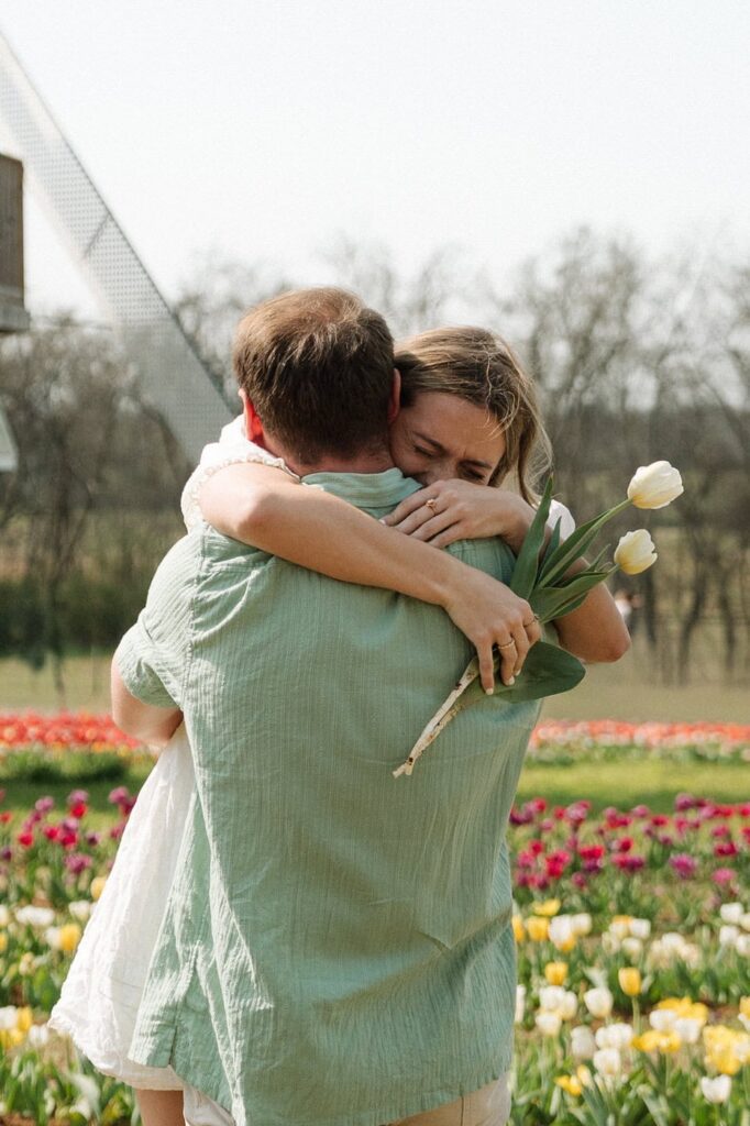 couple hugging during an emotional moment at tulip farm in nashville