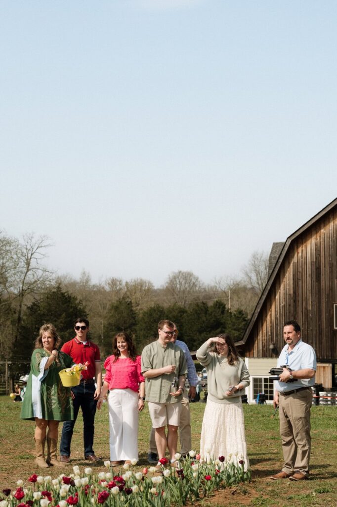 family waiting to congratulate the newly engaged couple at the tulip farm