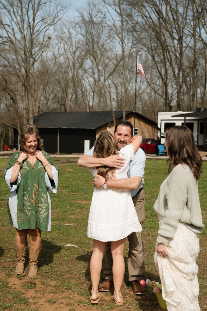 girl hugging her dad after getting engaged at nashville flower farm