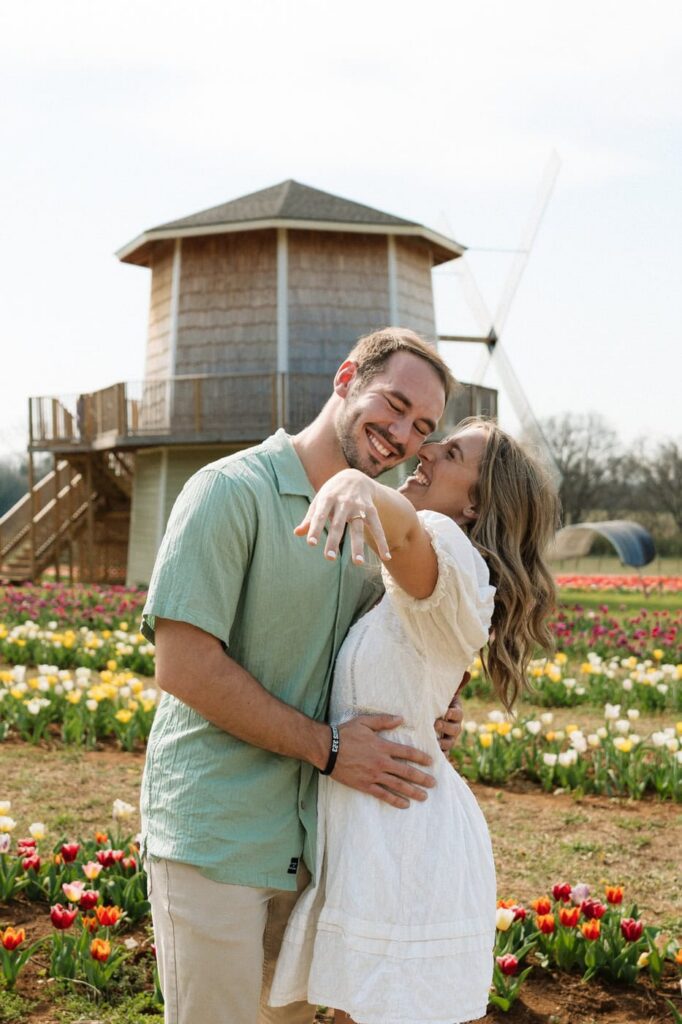 couple posing after getting engaged at tulip farm in nashville tennessee