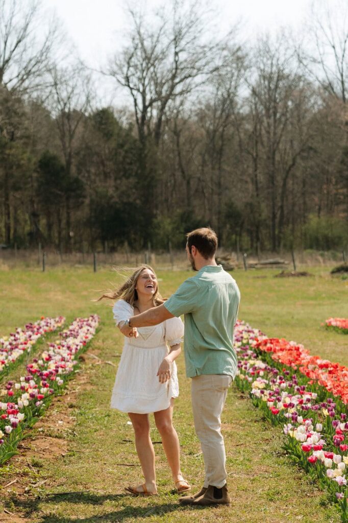 couple dancing and laughing at the tulip farm in tennessee