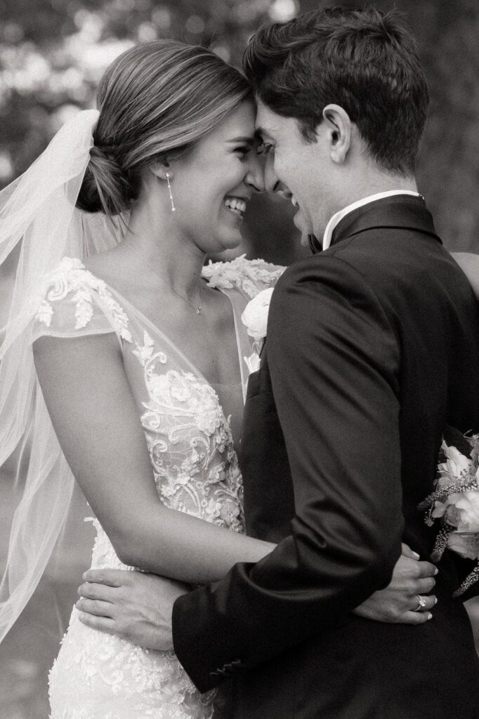 bride and groom hugging and laughing on their wedding day