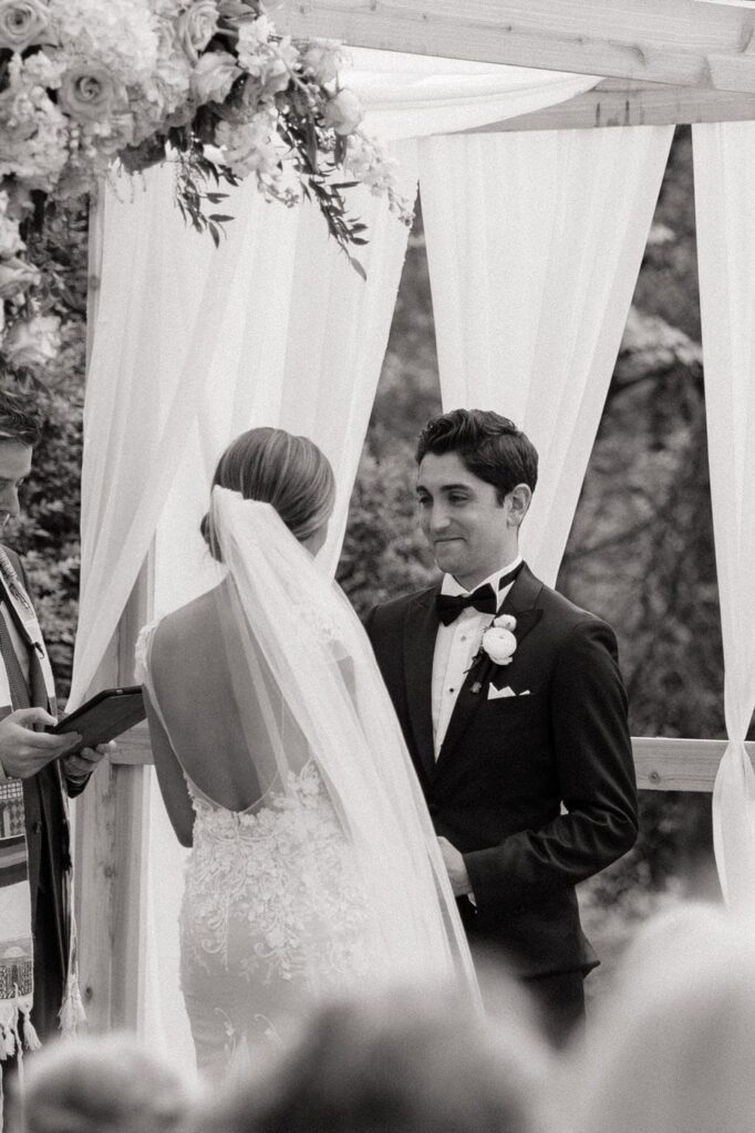 groom smiling at his bride during wedding ceremony in nashville