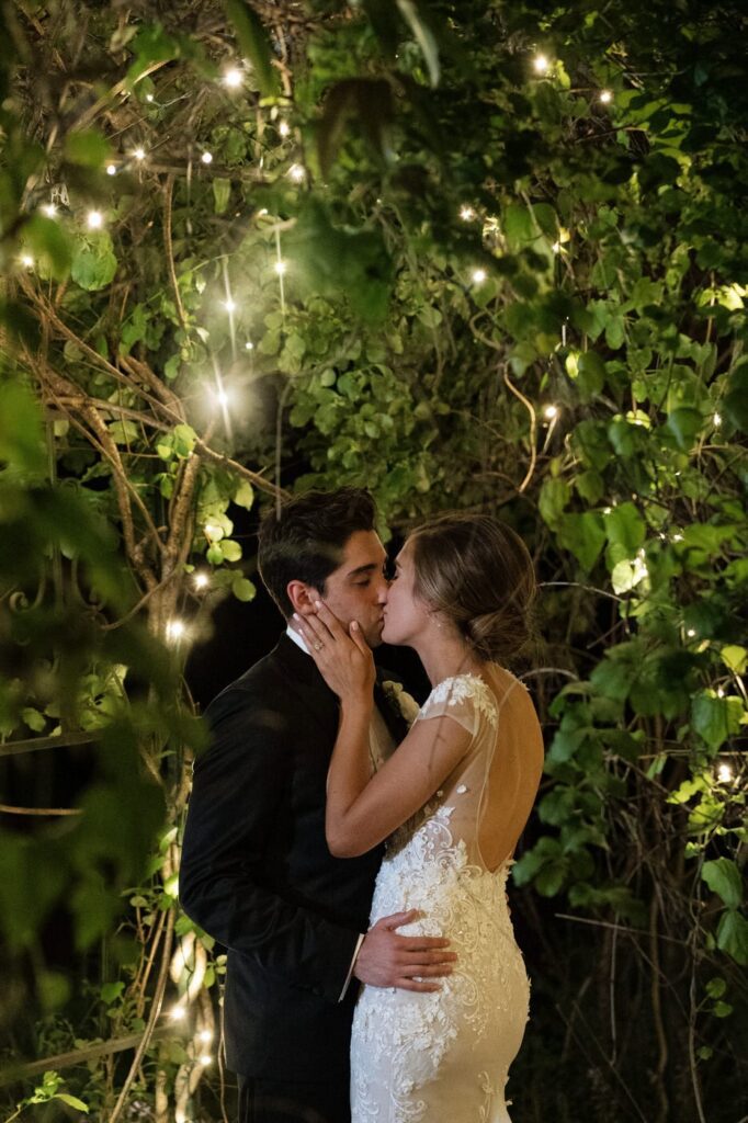 couple kissing in the gardens at nashville wedding venue