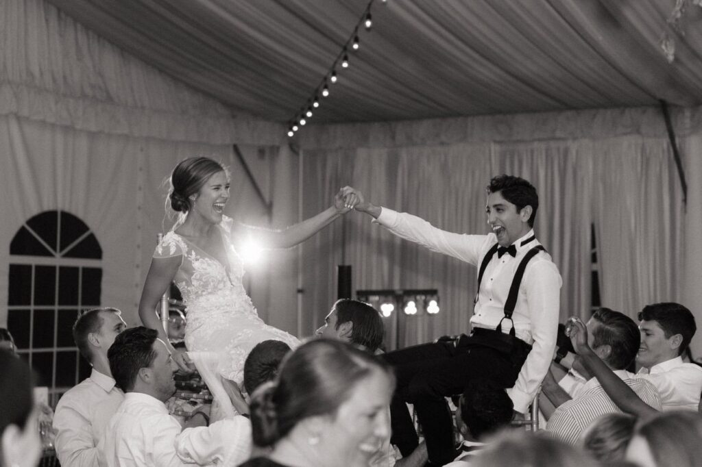 couple holding hands and celebrating during the hora at nashville wedding