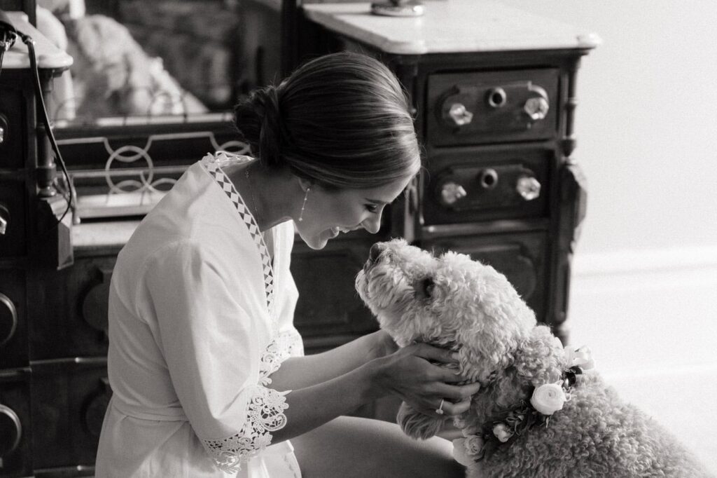 candid moment between bride and her dog on her wedding day